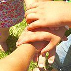 Top down view of three people holding hands 