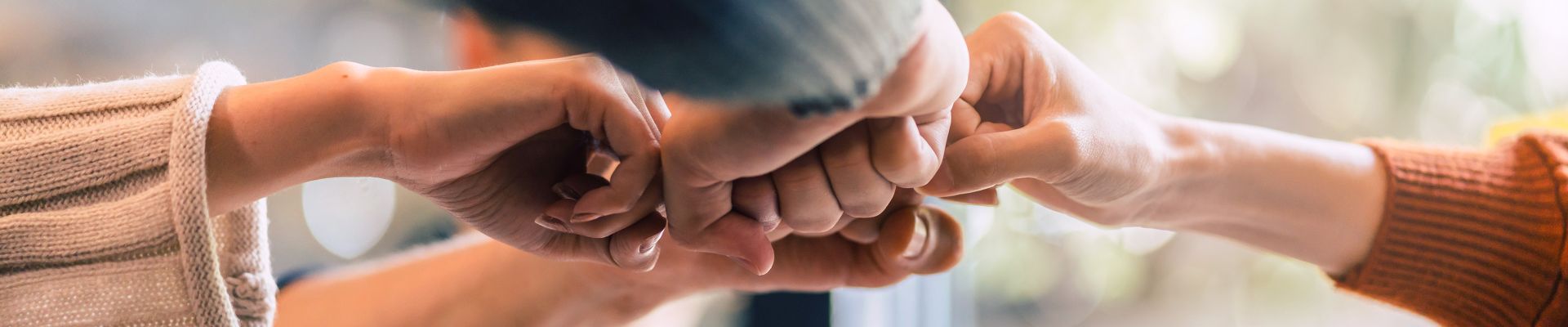 Four hands fist-bumping