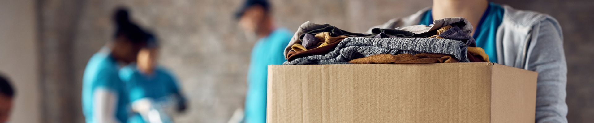 Person holding box of clothing