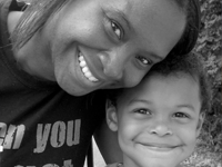 Woman posing and smiling with a young boy