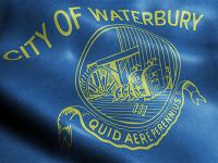 Close up of fabric that has the City of Waterbury emblem on it. It reads "City of Waterbury. Quid Aere Perennius"