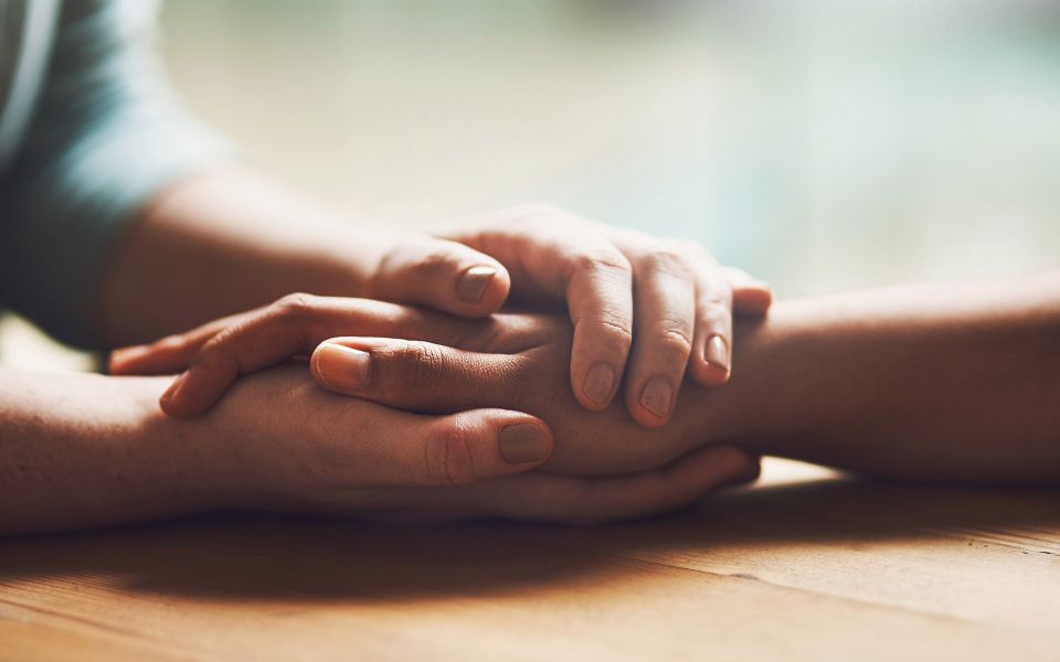 Close up of two people holding hands